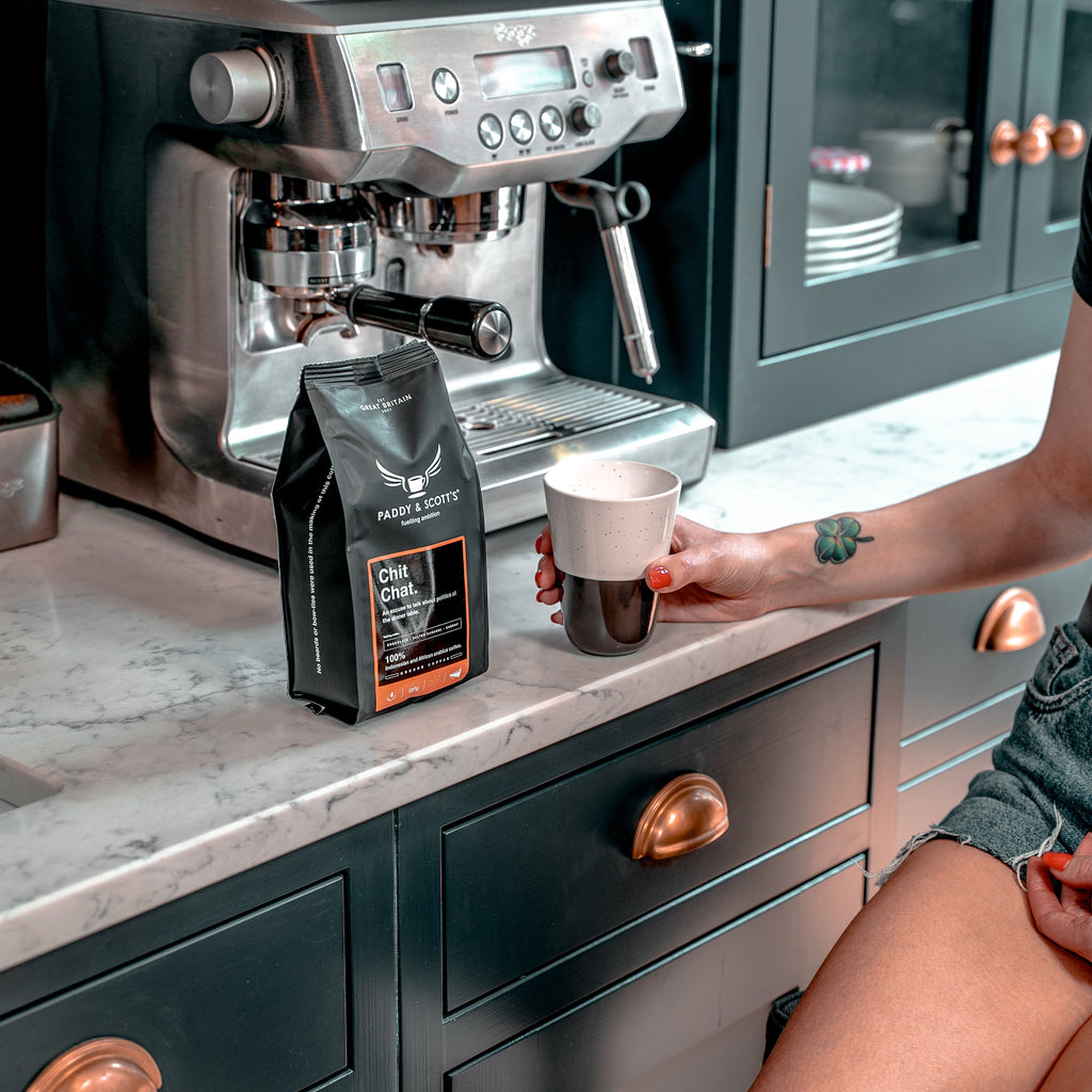 Paddy & Scott's Chit Chat Ground Coffee Next To Espresso Machine