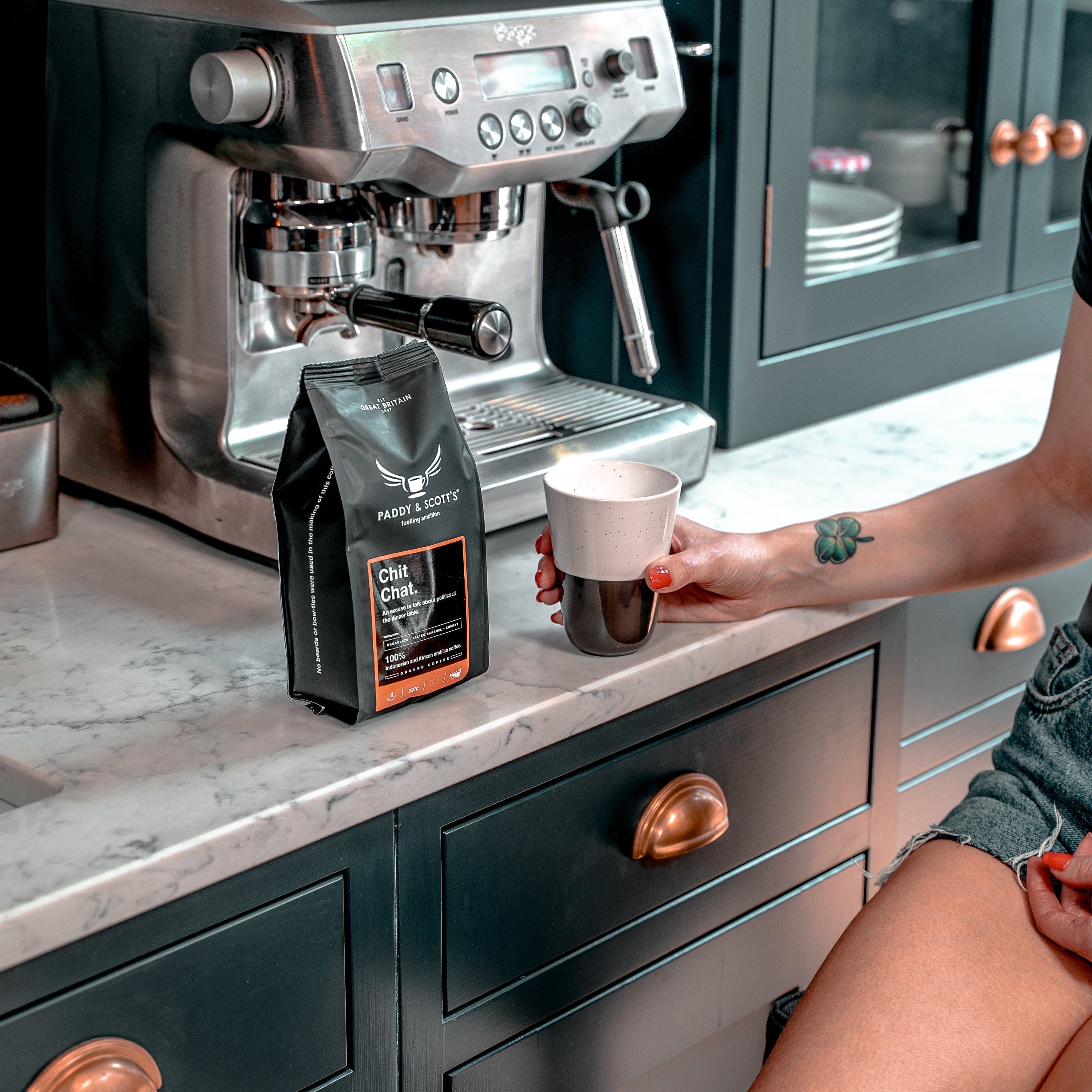 Paddy & Scott's Chit Chat Ground Coffee Next To Espresso Machine